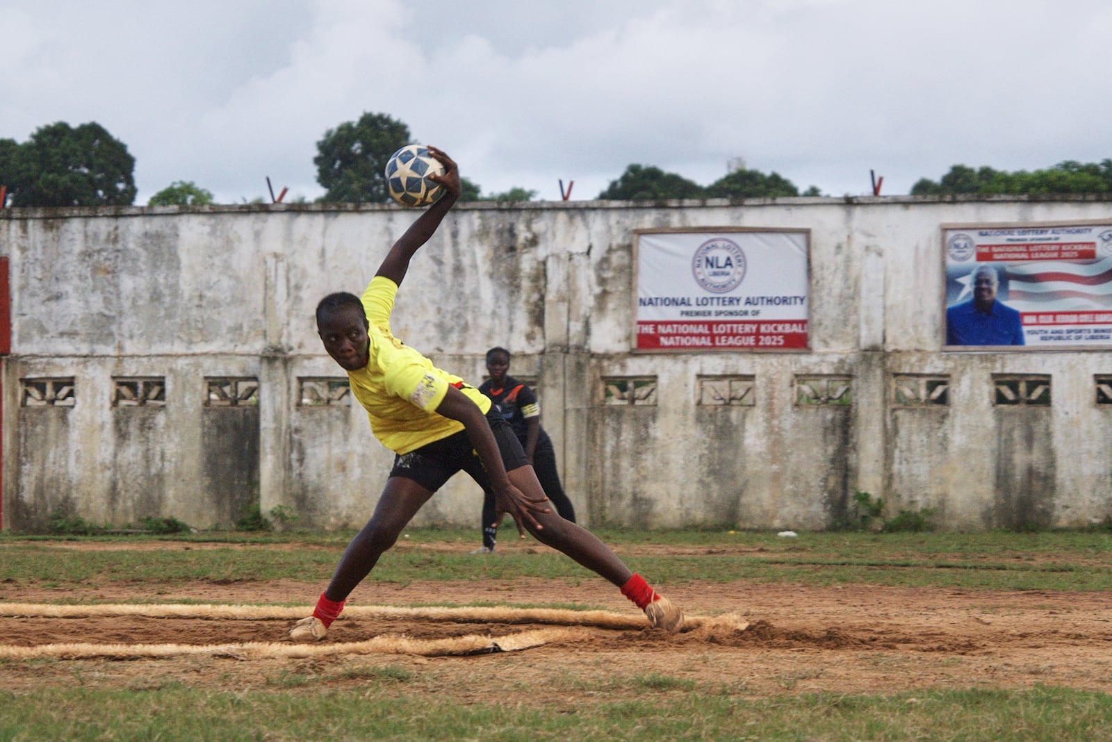 A kickball pitcher winds up before throwing a ball during a match at the Samuel Kanyon Doe Stadium in Monrovia, Liberia, June 14, 2025. (AP Photo/Annie Risemberg)