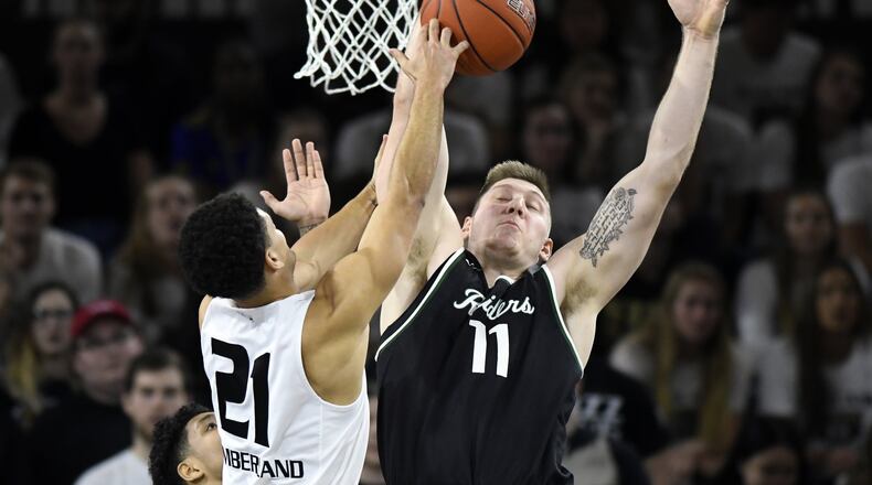 Wright State’s Loudon Love blocks Oaklands Jaevin Cumberland during Saturday’s game at Oakland. Cumberland is a Wilmington HIgh School product. Jose Juarez/CONTRIBUTED