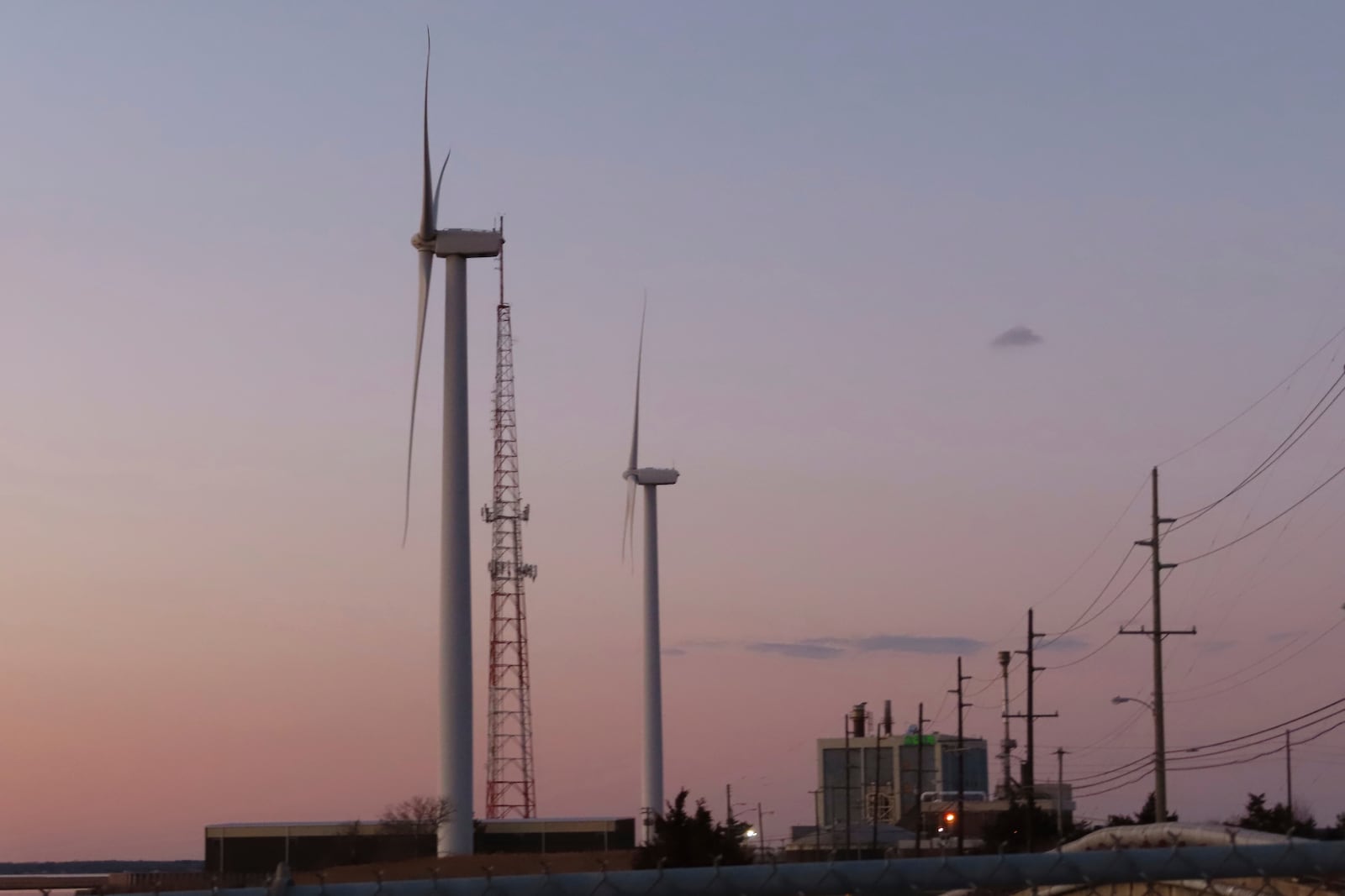 FILE - The sun sets behind a land-based wind farm in Atlantic City, N.J., on Feb. 10, 2022. (AP Photo/Wayne Parry, File)