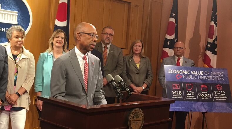 Ohio State University president Michael Drake speaks at the Statehouse on Tuesday about why higher education is a good investment. Behind him are Central State University president Cynthia Hammond-Jackson and Wright State University president Cheryl Schrader.