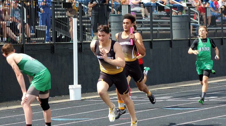 Shawnee’s Jack McCrory (left) takes the baton from Robie Glass during the 800-meter relay Saturday at the Division II district track and field championships at Graham High School. The team of Matt Jarzab, Glass, McCrory and Cyres Cooper set a district meet record in 1:31.01, beating the previous best of 1:31.19 set by Carroll in 2015. Greg Billing / Contributed