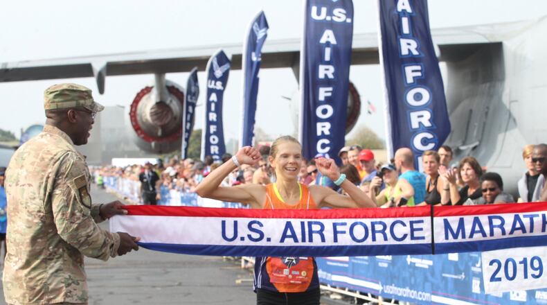 Women’s winner Ann Alyanak crosses the finish line at the Air Force Marathon on Saturday, Sept. 21, 2019, at Wright-Patterson Air Force Base in Fairborn. David Jablonski/Staff