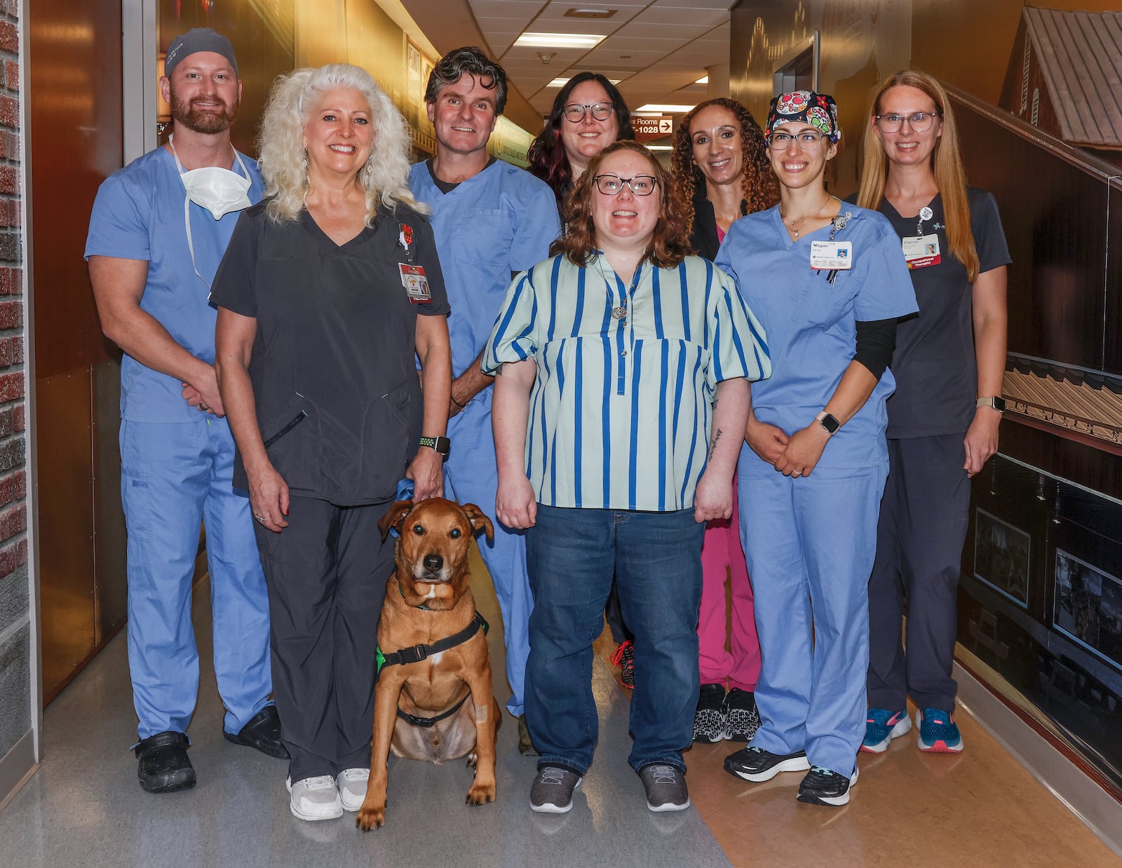 Mallory Prince, bottom center, poses for a photo on Wednesday, Nov. 19, 2025, at Mercy Health Springfield, with the clinical team that treated her after she had a stroke. JOSEPH COOKE/STAFF