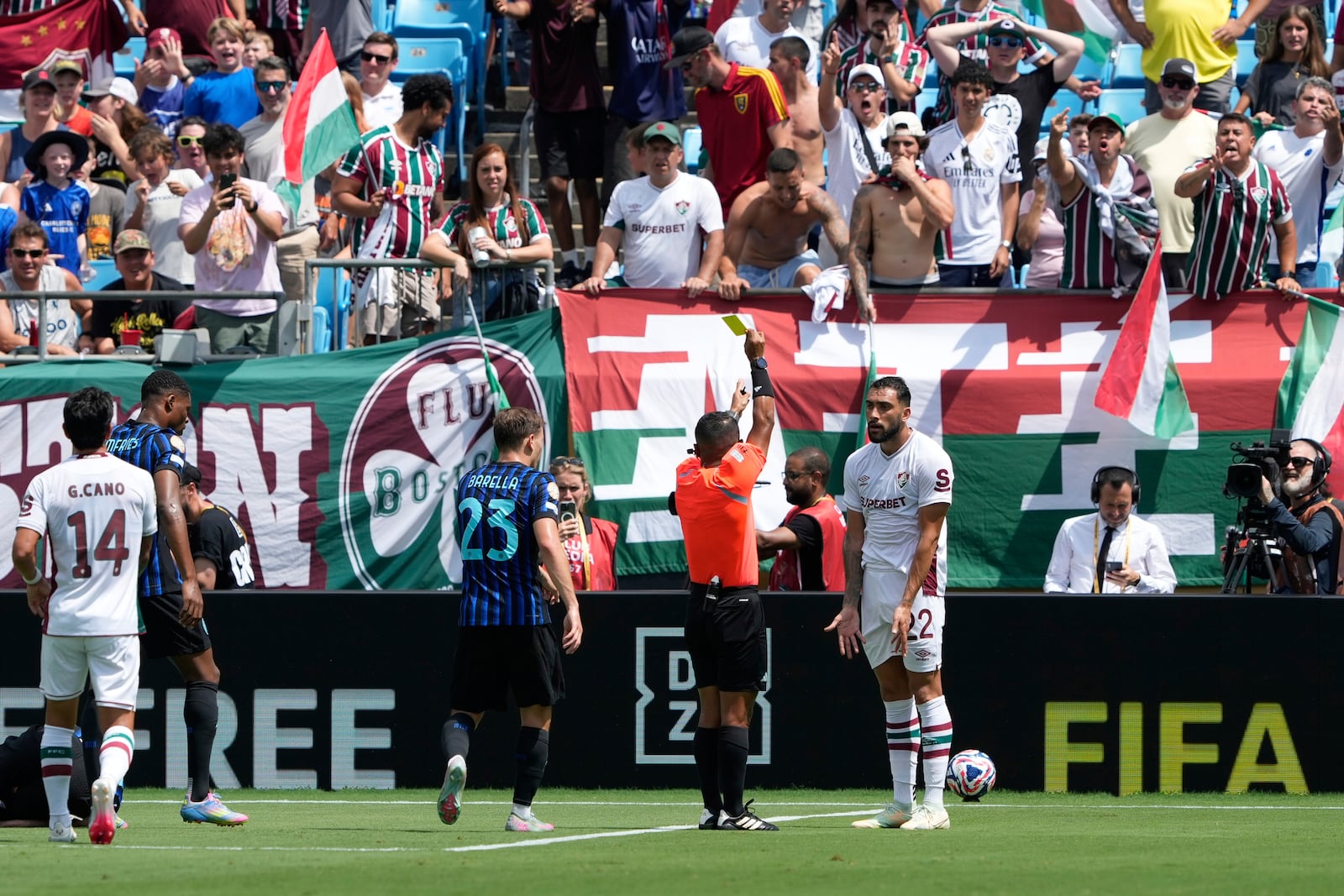 Referee Ivan Arcides Barton Cisneros, of El Salvador, shows the yellow card to Fluminense's Juan Pablo Freytes during the Club World Cup round of 16 soccer match between Inter Milan and Fluminense in Charlotte, N.C., Monday, June 30, 2025. (AP Photo/Chris Carlson)
