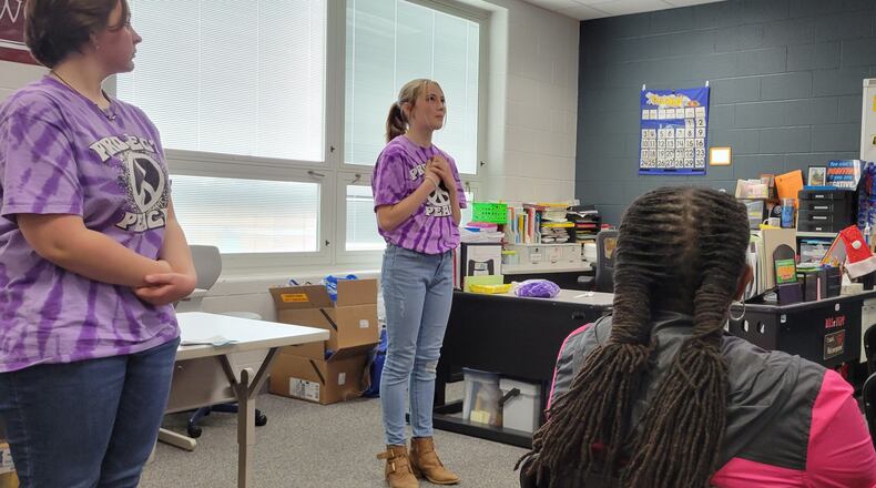 Schaefer Middle School students Kairi Krauss, center, and Gabrielle Shoemaker speak to guests on how gun violence is affecting Springfield students during a presentation at the school on Friday, April 29. Several students formed a group called Project Peace to counter the problem.