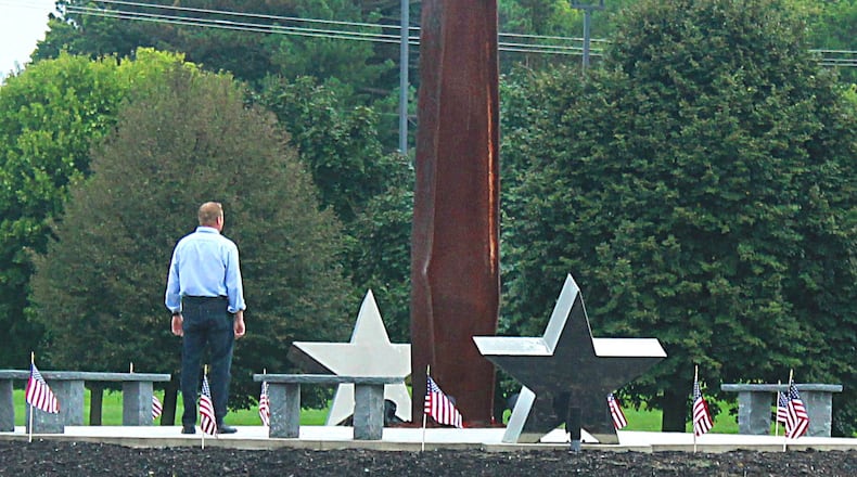 A man pays his respect at the 9/11 Memorial in Freedom Grove to honor the victims who died that day. JEFF GUERINI/STAFF