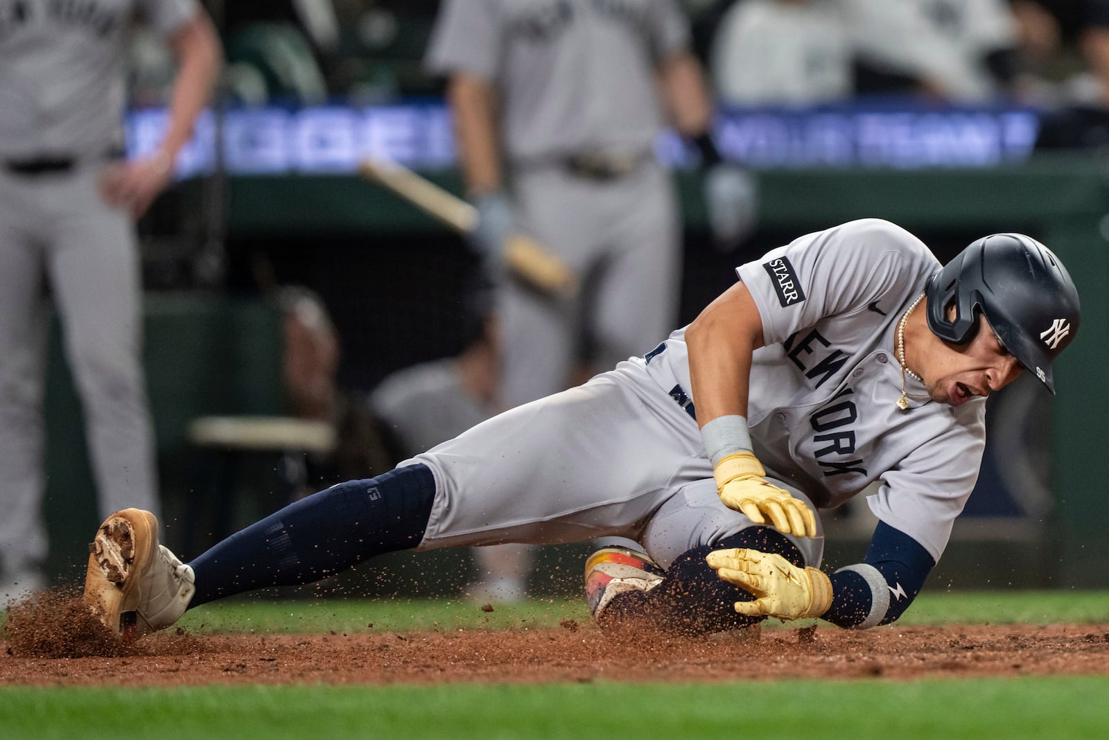 New York Yankees' Oswaldo Cabrera injures his leg while scoring a run during the ninth inning of a baseball game against the Seattle Mariners, Monday, May 12, 2025, in Seattle. (AP Photo/Stephen Brashear)