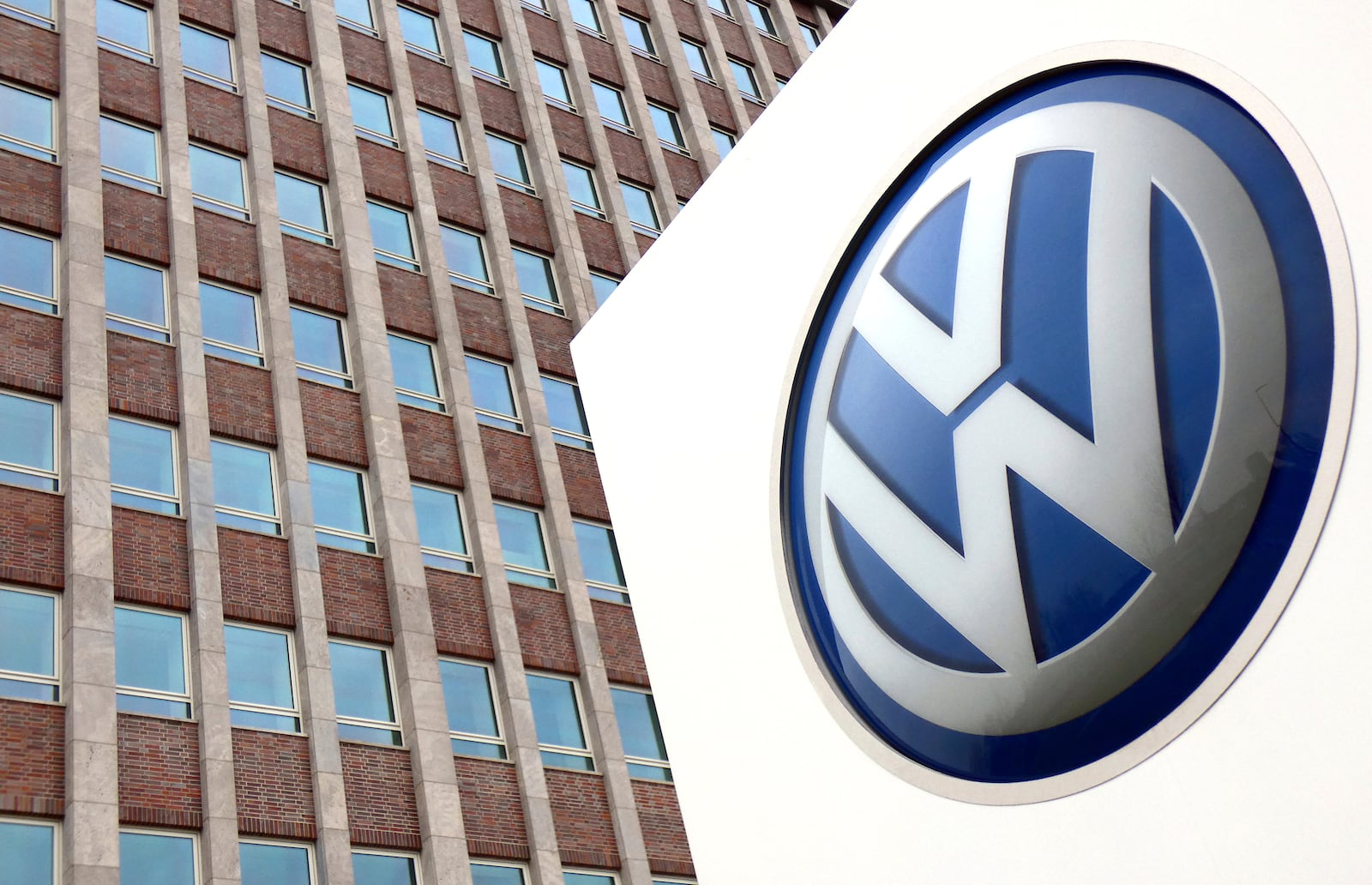 FILE - In this April 13, 2018 file photo, Volkswagen logo is pictured in front of a company building in Wolfsburg, Germany. (AP Photo/Michael Sohn, File)