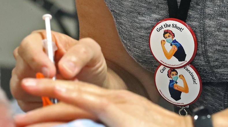 A Clark County resident gets a COVID-19 vaccine shot earlier this month at the Clark County Combined Health District's new vaccine center on Leffel Lane. Residents can now receive the Pfizer booster dose at the center. BILL LACKEY/STAFF