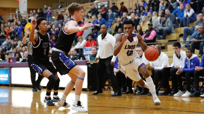 Emanuel Christian Academy’s Jason Channels drives past Cincinnati Christian’s Cody Anderson during their Division IV district final game on Friday night at the Vandalia Butler Student Activity Center. CONTRIBUTED PHOTO BY MICHAEL COOPER