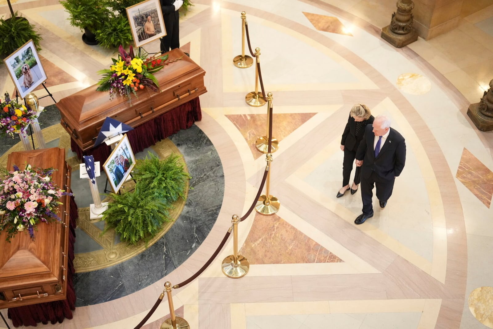 Gov. Tim Walz and his wife Gwen Walz walk into the rotunda to pay their respect to former Minnesota House Speaker Melissa Hortman, who will lie in state with her husband, Mark, and their golden retriever, Gilbert at the Minnesota Capitol rotunda on Friday, June 17, 2025 in St. Paul, Minn. (Alex Kormann/Star Tribune via AP)