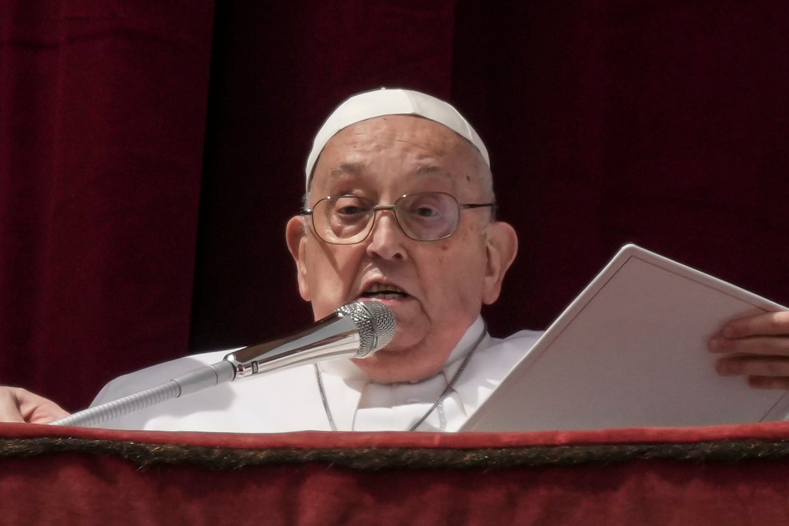 Pope Francis bestows the Urbi et Orbi (Latin for to the city and to the world) blessing from the central lodge of St. Peter's Basilica at the end of the Easter mass presided over by Cardinal Angelo Comastri in St. Peter's Square at the Vatican Sunday, April 20, 2025. (AP Photo/Andrew Medichini)