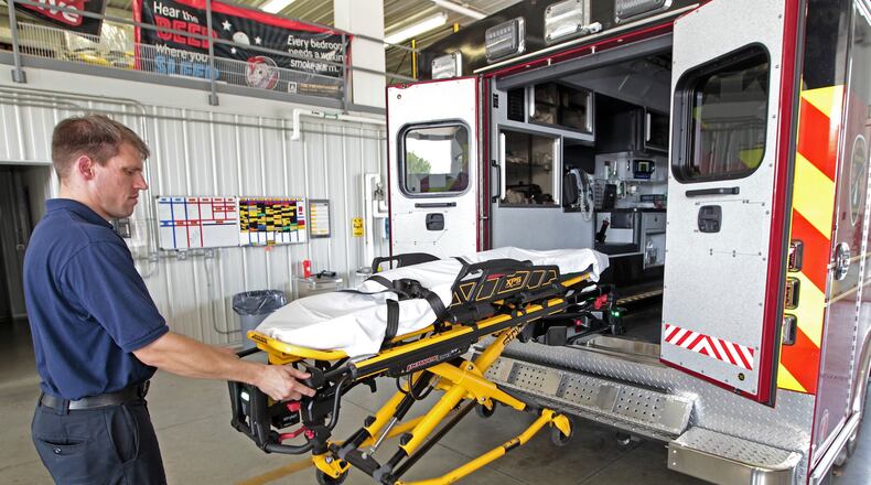 Dave Jones, a firefighter/paramedic with Bethel Twp. Fire, demonstrates the self loading cot in the departments new medic unit Wednesday. Bill Lackey/Staff
