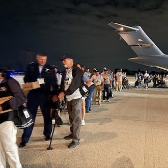Veterans and their guardians line up on Wright-Patterson Air Force Base tarmac Sunday Sept. 21, 2025 to board a 445th Airlift Wing C-17 for a one-day "Honor Flight" trip to Washington, D.C. THOMAS GNAU/STAFF