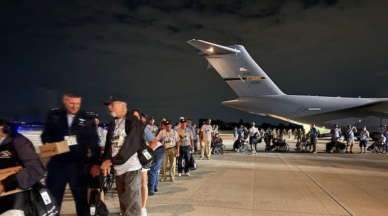 Veterans and their guardians line up on Wright-Patterson Air Force Base tarmac Sunday Sept. 21, 2025 to board a 445th Airlift Wing C-17 for a one-day "Honor Flight" trip to Washington, D.C. THOMAS GNAU/STAFF