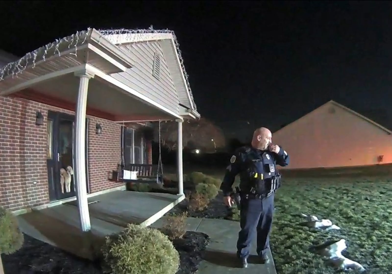 An officer stands outside the Flynn home on the night of the homicide. TIPP CITY POLICE.