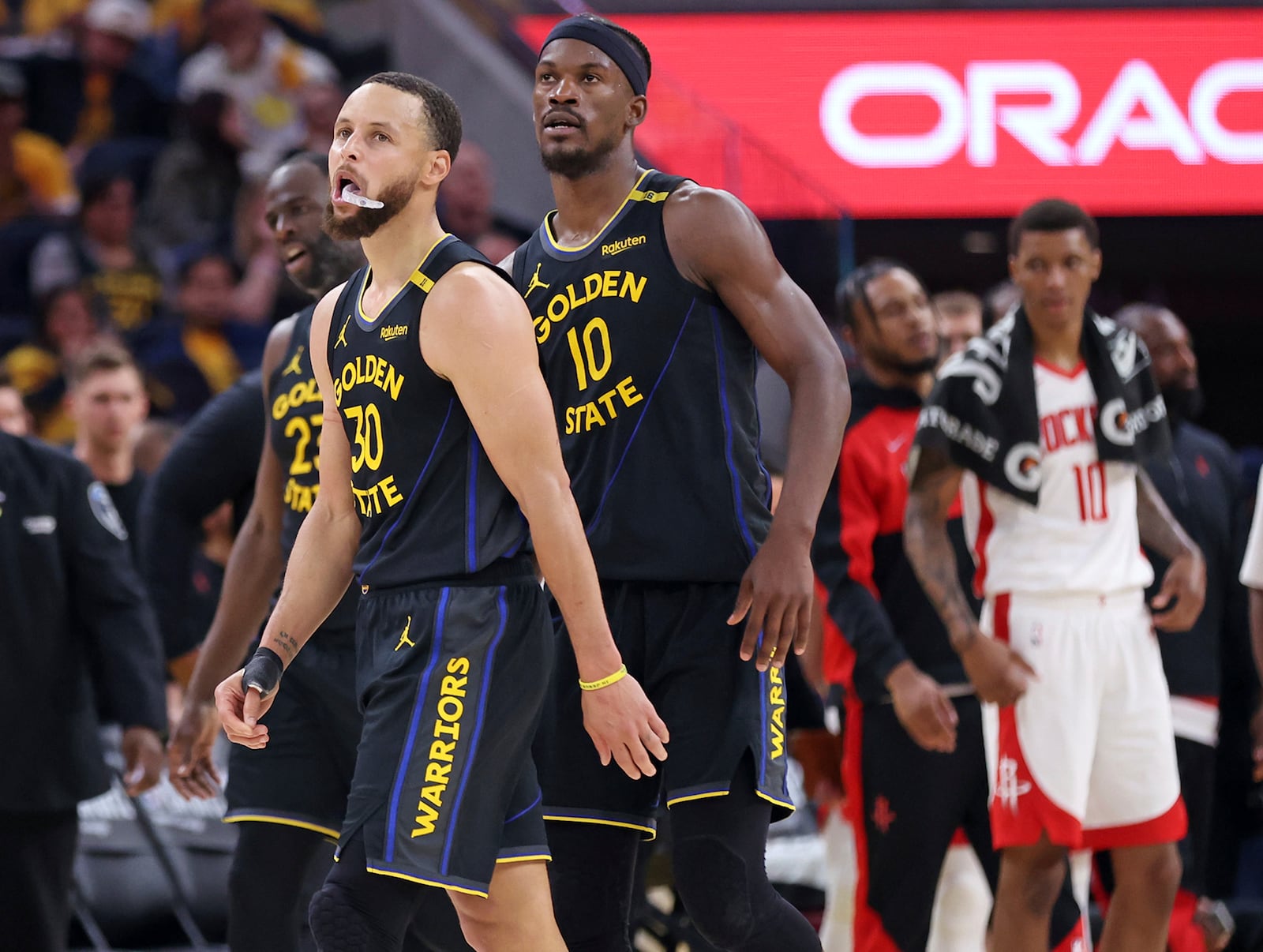 Golden State Warriors' Stephen Curry, Draymond Green and Jimmy Butler III head to the bench in fourth quarter of Game 6 of an NBA basketball first-round playoff series Friday, May 2, 2025, in San Francisco. (Scott Strazzante/San Francisco Chronicle via AP)