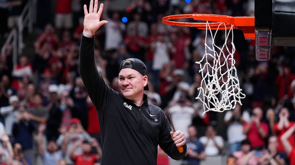 Arizona head coach Tommy Lloyd waves as he cuts down the net after a win over Purdue in the Elite Eight of the NCAA college basketball tournament, Saturday, March 28, 2026, in San Jose, Calif. (AP Photo/Godofredo A. Vásquez)