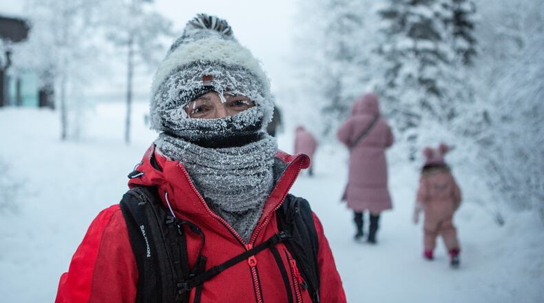 People walk in freezing temperatures in Ylläs, Finland, Friday, Jan. 9, 2026. (Satu Renko/Lehtikuva via AP)