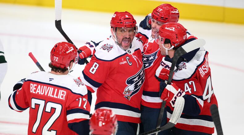 Washington Capitals left wing Alex Ovechkin (8) celebrates his goal with teammates during the third period of an NHL hockey game against the Minnesota Wild, Friday, Oct. 17, 2025, in Washington. (AP Photo/Nick Wass)