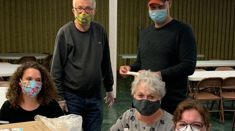 Volunteers at Central Community Kitchen prepared utensils for carryout meals during the coronavirus pandemic.