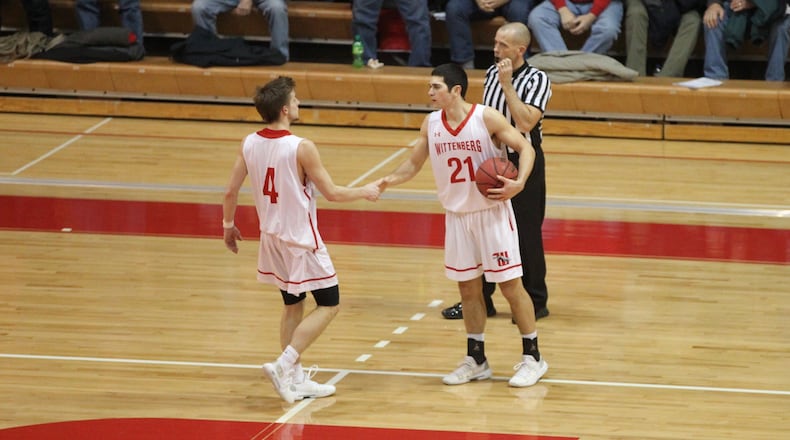 Wittenberg’s Jordan Pumroy, left, and Jake Bertemes shake hands after a victory against Wabash on Feb. 13, 2019, at Pam Evans Smith Arena in Springfield. David Jablonski/Staff