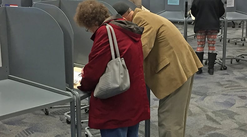 Voters cast their ballots at an Urbana poll Tuesday. BILL LACKEY/STAFF