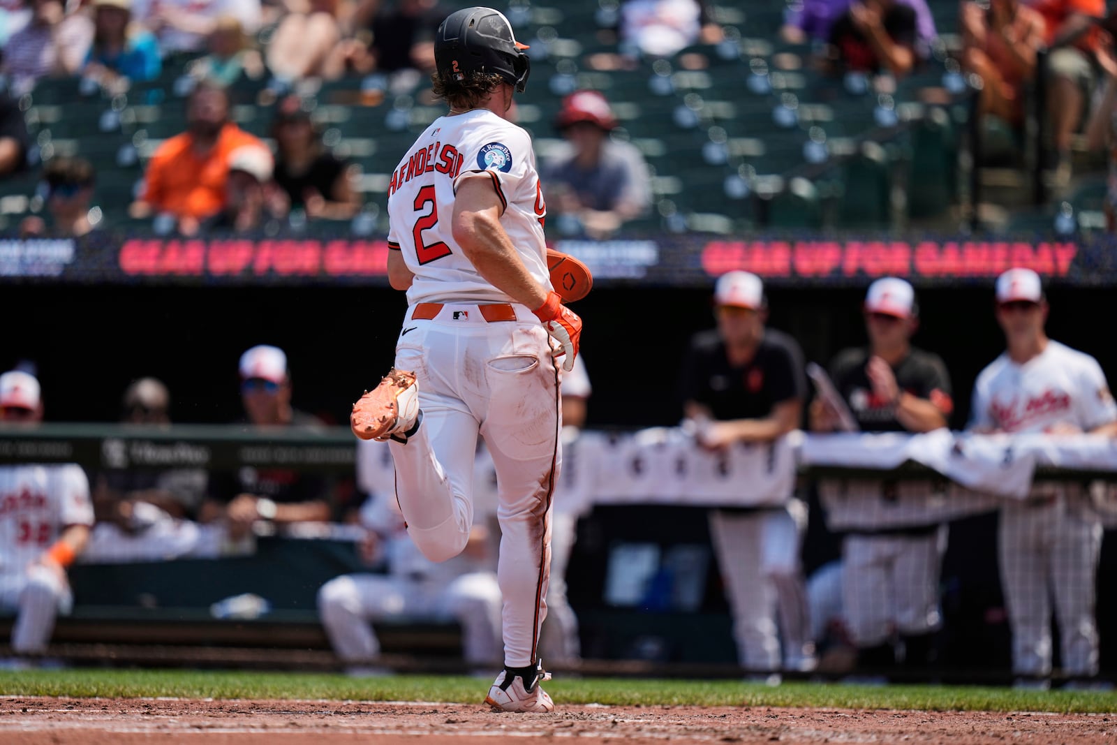 Baltimore Orioles' Gunnar Henderson (2) scores on a sacrifice fly hit by Cedric Mullins during the third inning in the first baseball game of a doubleheader against the Toronto Blue Jays, Tuesday, July 29, 2025, in Baltimore. (AP Photo/Stephanie Scarbrough)