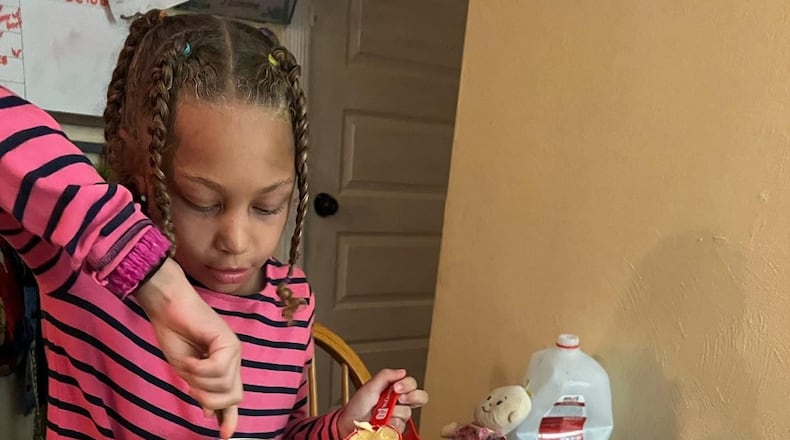 Jasmine, Pamela’s daughter, makes Christmas cookies, one of their favorite traditions. CONTRIBUTED