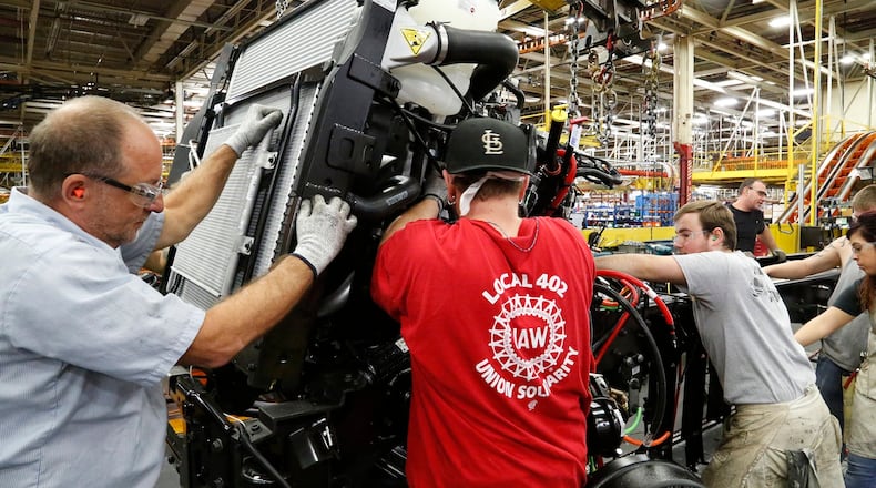 In this file photo, workers assemble a truck on the assembly line at Navistar in 2017. The company was acquired by a subsidiary of Volkswagen in 2021. Bill Lackey/Staff
