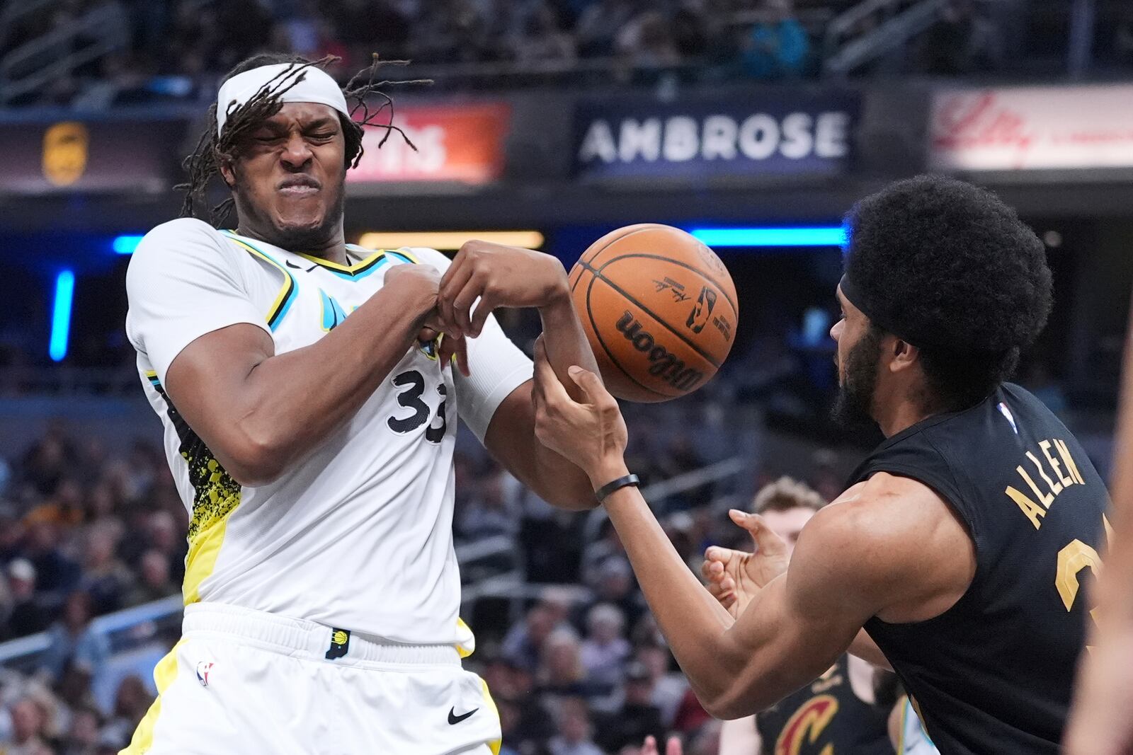 Indiana Pacers center Myles Turner (33) and Cleveland Cavaliers center Jarrett Allen (31) fight for a rebound during the first half of an NBA basketball game in Indianapolis, Thursday, April 10, 2025. (AP Photo/Michael Conroy)