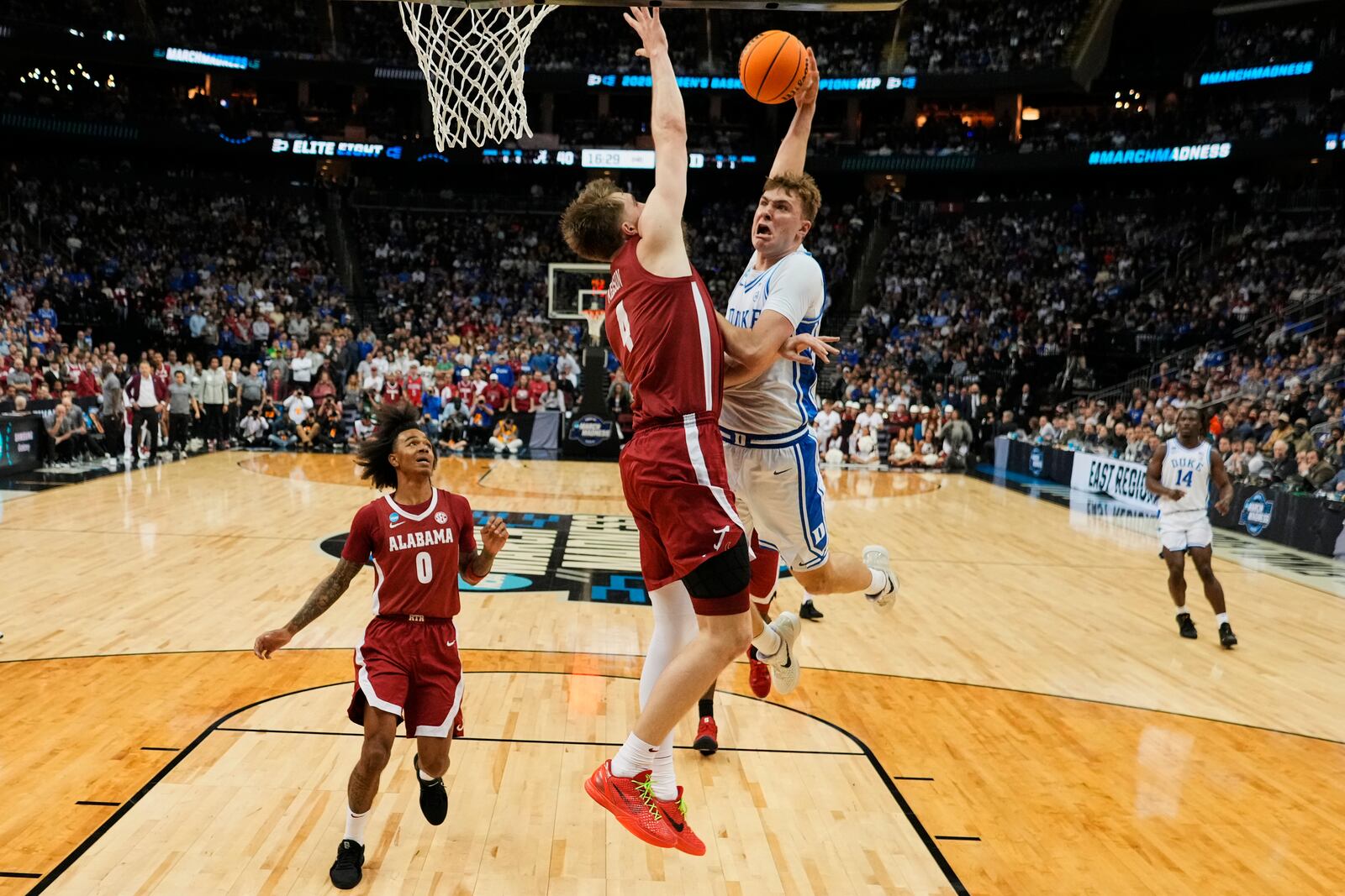 Alabama's Grant Nelson (4) defends Duke's Cooper Flagg (2) in the second half of a college basketball game during the Elite 8 round of the NCAA men's tournament Saturday, March 29, 2025, in Buffalo, N.Y. (AP Photo/Frank Franklin II)