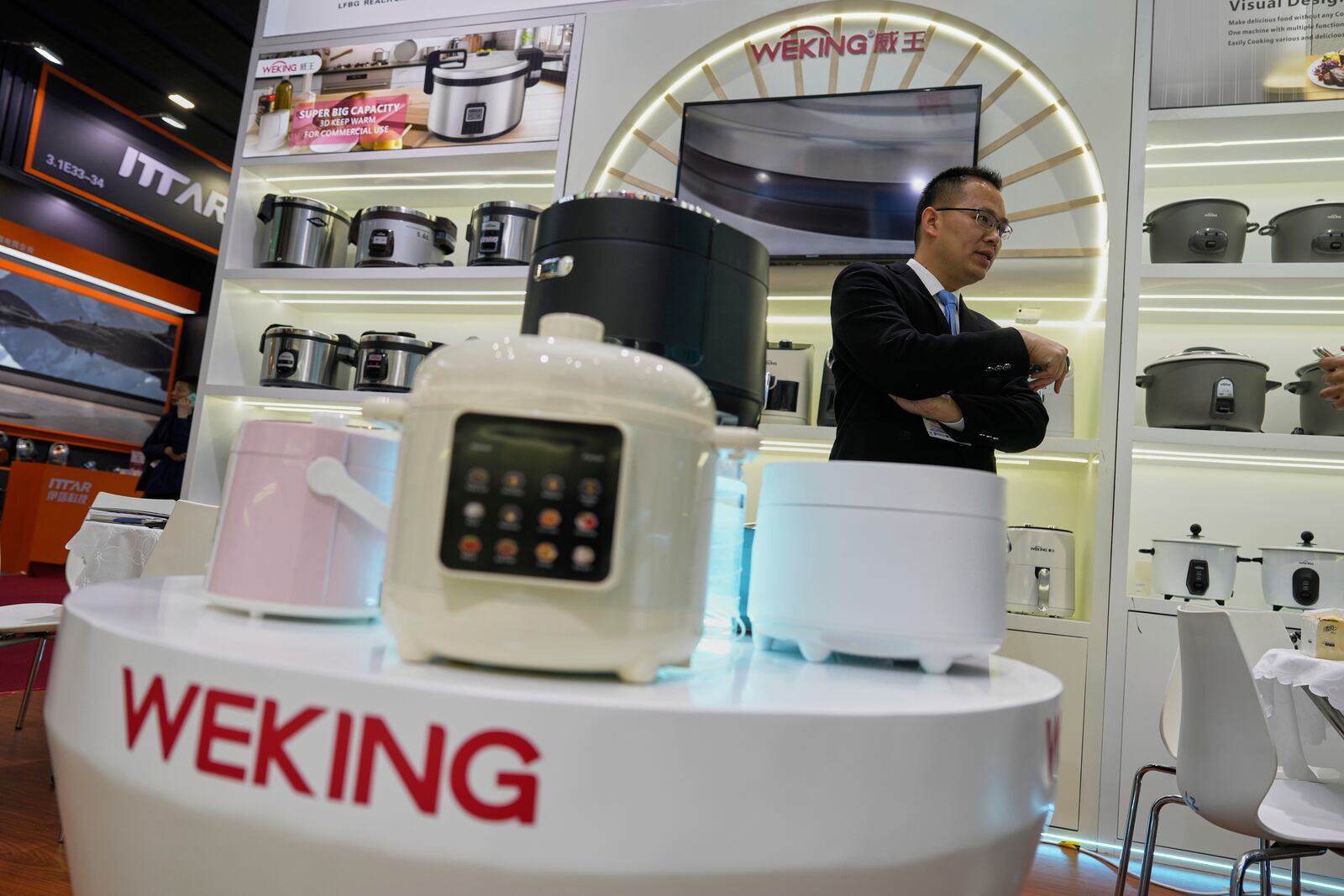 Wallace Huang, export business director of Weking, talks about the Chinese manufacturer of rice cookers and heaters at the 137th Canton Fair in Guangzhou in southern China's Guangdong province on Wednesday, April 16, 2025. (AP Photo/Ng Han Guan)