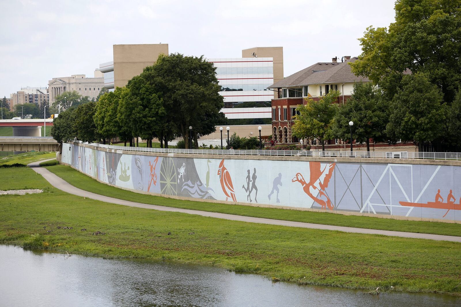 The River Run Mural spans 950 feet next to the Great Miami River across from RiverScape Metro Park. Designed by artist Amy Deal it was painted on the flood wall by artists from K12 Gallery. River Run opens on May 5 LISA POWELL / STAFF