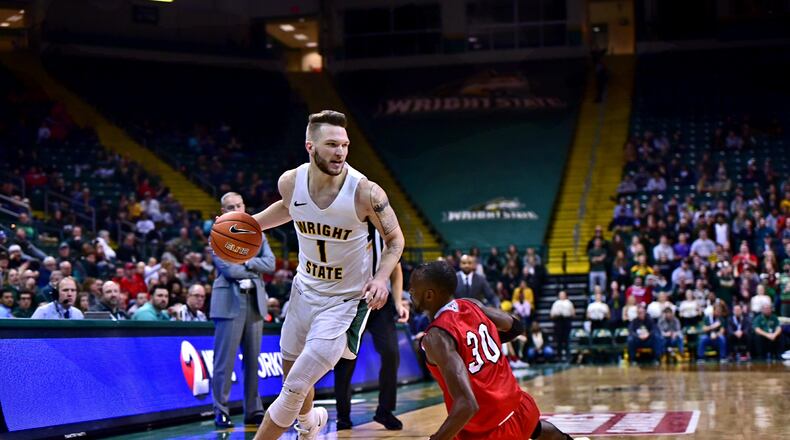 Wright State’s Bill Wampler drives around Miami’s Aboulaye Harouna during Wednesday night’s gamea at the Nutter Center. Joseph Craven/CONTRIBUTED