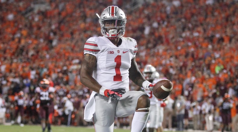 Braxton Miller celebrates his 53-yard touchdown run. David Jablonski/Staff
