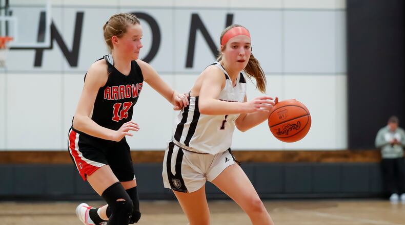Greenon's Sarah Riley (right) tries to drive past Tecumseh's Sammy Russell during a game last season. Michael Cooper/CONTRIBUTED