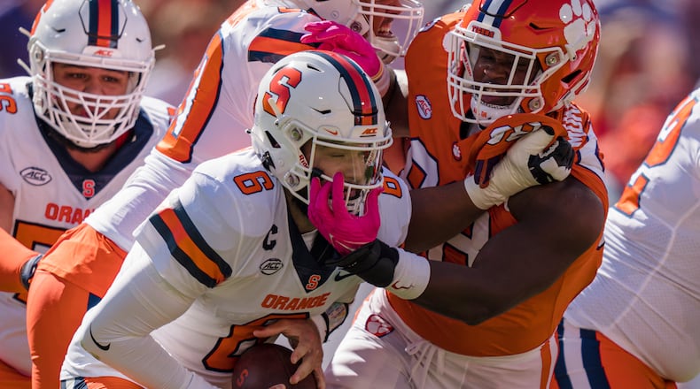 Clemson defensive end Myles Murphy (98) tries to sack Syracuse quarterback Garrett Shrader (6), but was called for a face mask penalty, in the first half during an NCAA college football game on Saturday, Oct. 22, 2022, in Clemson, S.C. (AP Photo/Jacob Kupferman)
