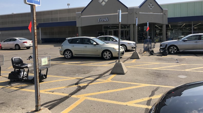 Three Atlanta-area people were arrested in the parking lot of this Meijer in Warren County with equipment used to skim credit cards and gift, bank and credit/debit cards, including one reported missing in 2017. The driver was also charged with parking in a handicapped spot. STAFF/LAWRENCE BUDD