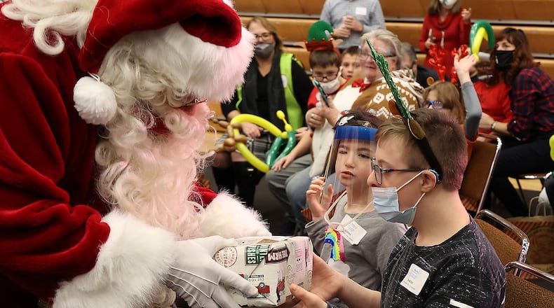 Dozens of children throughout Clark County got to have some holiday fun and meet Santa during the annual Springfield Rotary Club's Christmas Party for Children with Disabilities Monday at Wittenberg University. BILL LACKEY/STAFF