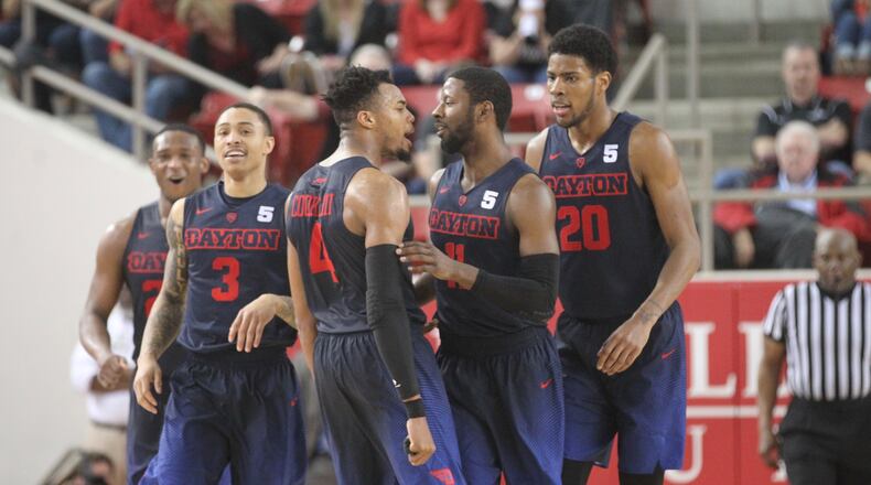 Dayton seniors (left to right) Kendall Pollard, Kyle Davis, Charles Cooke and Scoochie Smith, plus sophomore Xeyrius Williams, react after Smith’s third 3-pointer in overtime against Davidson on Friday, Feb. 24, 2017, at Belk Arena in Davidson, N.C.