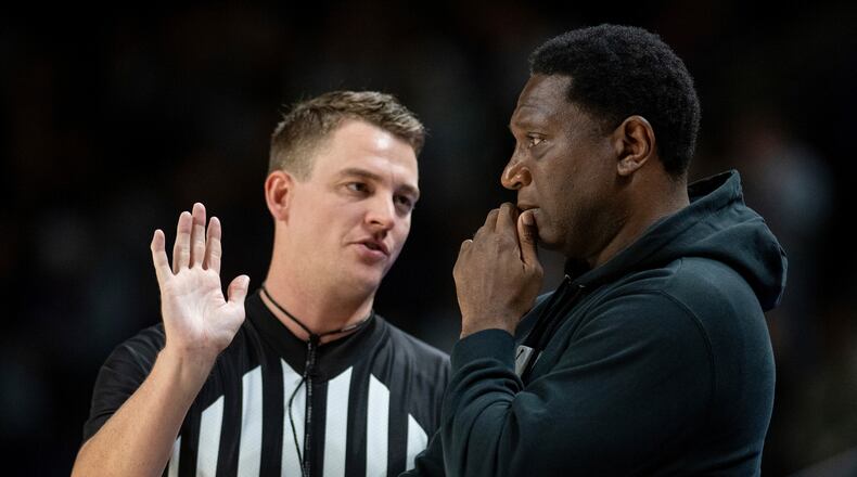 Howard head coach Kenny Blakeney, right, confers with a referee during the first half of an NCAA college basketball game against James Madison in Harrisonburg, Va., Sunday, Nov. 12, 2023. (Daniel Lin/Daily News-Record via AP)