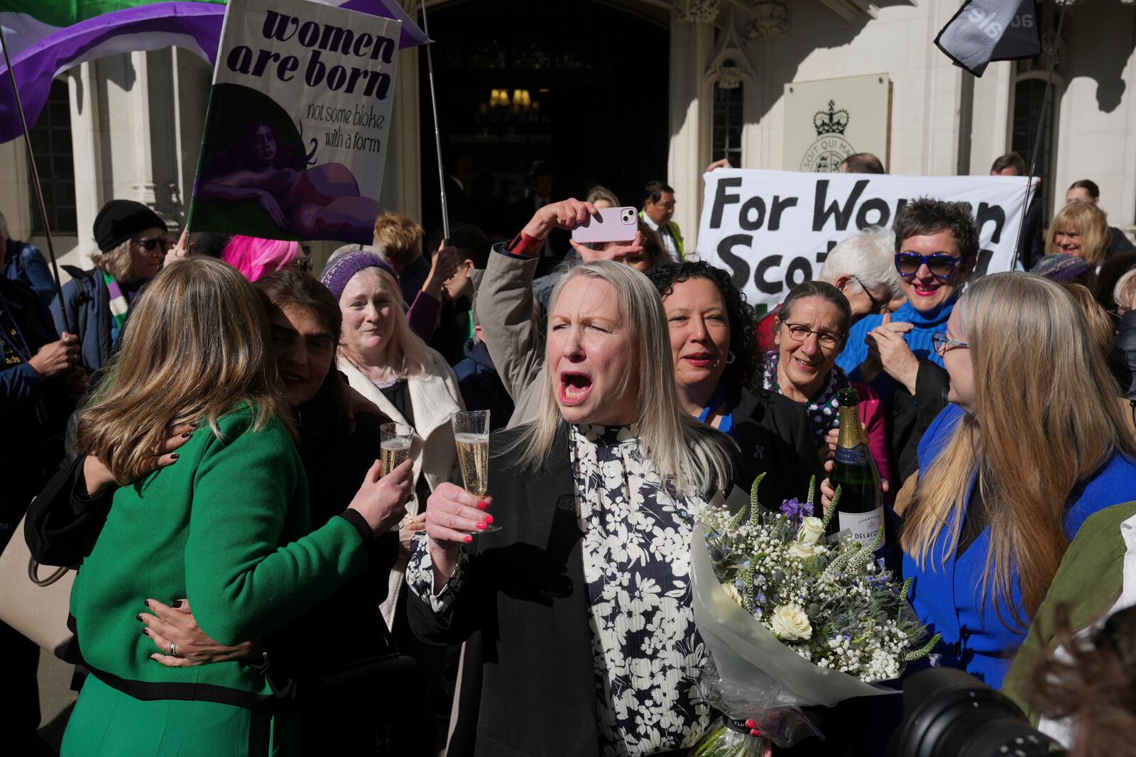 Marion Calder and Susan Smith from For Women Scotland, celebrate outside the Supreme Court to challenge gender recognition laws, in London, Wednesday, April 16, 2025. (AP Photo/Kin Cheung)