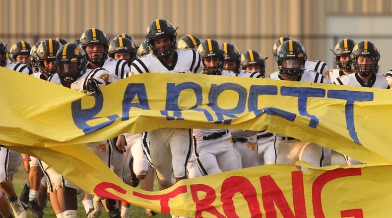 Springfield Shawnee players ran through a #BarrettStrong banner before a game this season. DAVID JABLONSKI/STAFF