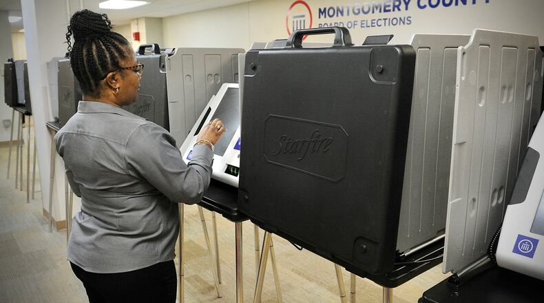 Inger Marsh looks over one of the polling machines at the Montgomery County Board of Elections on Wednesday March 24, 2022. MARSHALL GORBY\STAFF