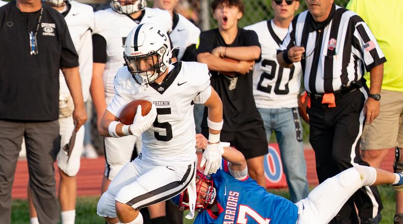 Greenon High School junior Colton Workman runs past Northwestern freshman Carson Kluczysnki during their game on Friday, Aug. 29 at Taylor Field in Springfield. The Warriors won 42-7. RODNEY GETZ/CONTRIBUTED PHOTO