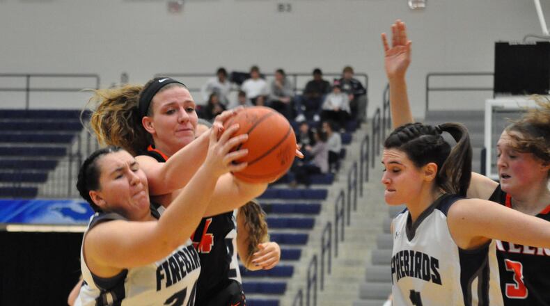 Beavercreek forward Lexi Moore battles with Fairmont forward Avery Alberts for a loose ball during the Beavers’ 50-39 win at Trent Arena on Wednesday. NICK DUDUKOVICH / CONTRIBUTED