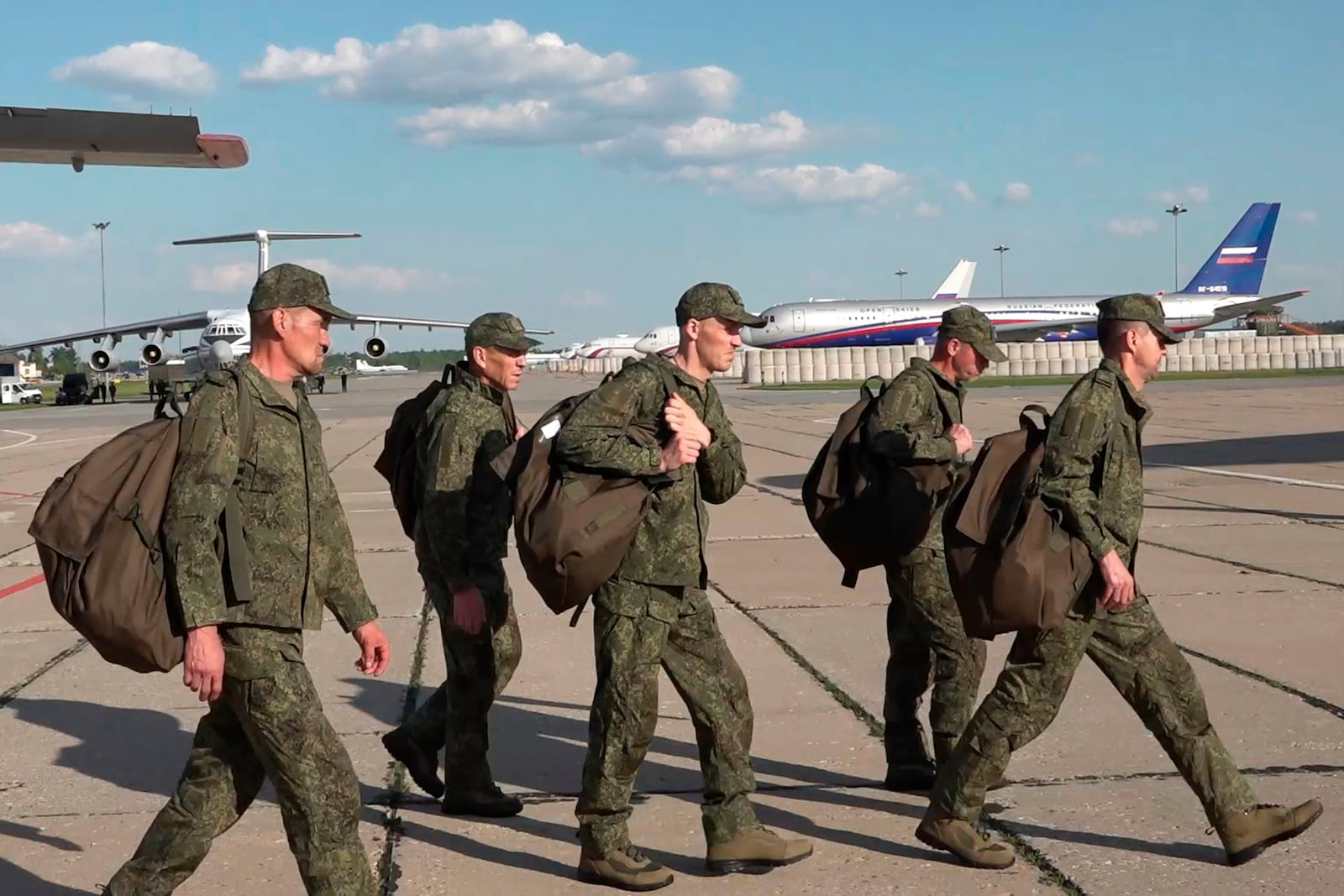 In this photo taken from video released by Russian Defense Ministry Press Service on Sunday, May 25, 2025, Russian servicemen leave a plane upon arrival to Chkalovsky airport, outside Moscow, Russia, after returning from captivity by a POWs exchange between Russia and Ukraine. (Russian Defense Ministry Press Service photo via AP)