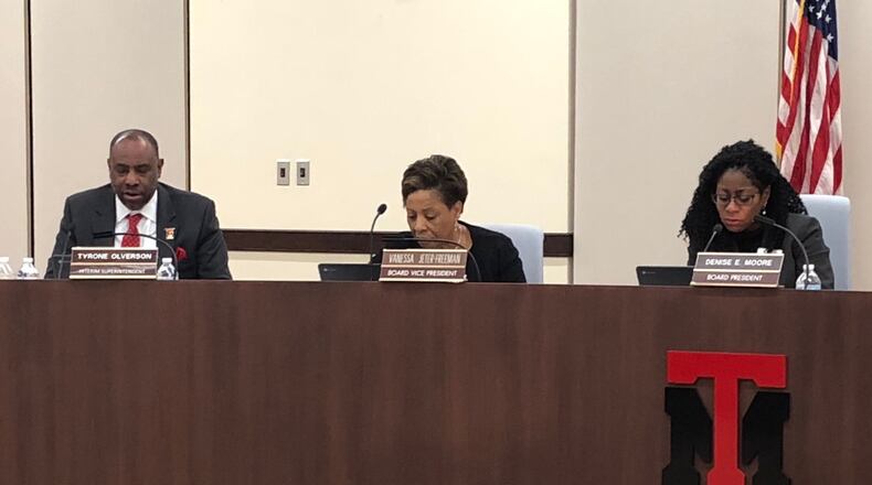 From left, Superintendent Tyrone Olverson and school board members Vanessa Jeter-Freeman and Denise Moore review the agenda at the Dec. 6, 2018 Trotwood-Madison school board meeting.