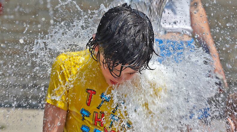 Pictured in this staff file photo is Anthony Reges, 7, standing under a bucket as it dumps cool water over him June 17, 2024. The National Weather Service is forecasting warm temperatures 80 degrees and higher for the month of August, so public health experts recommend practicing heat safety measures and staying hydrated. BILL LACKEY/STAFF